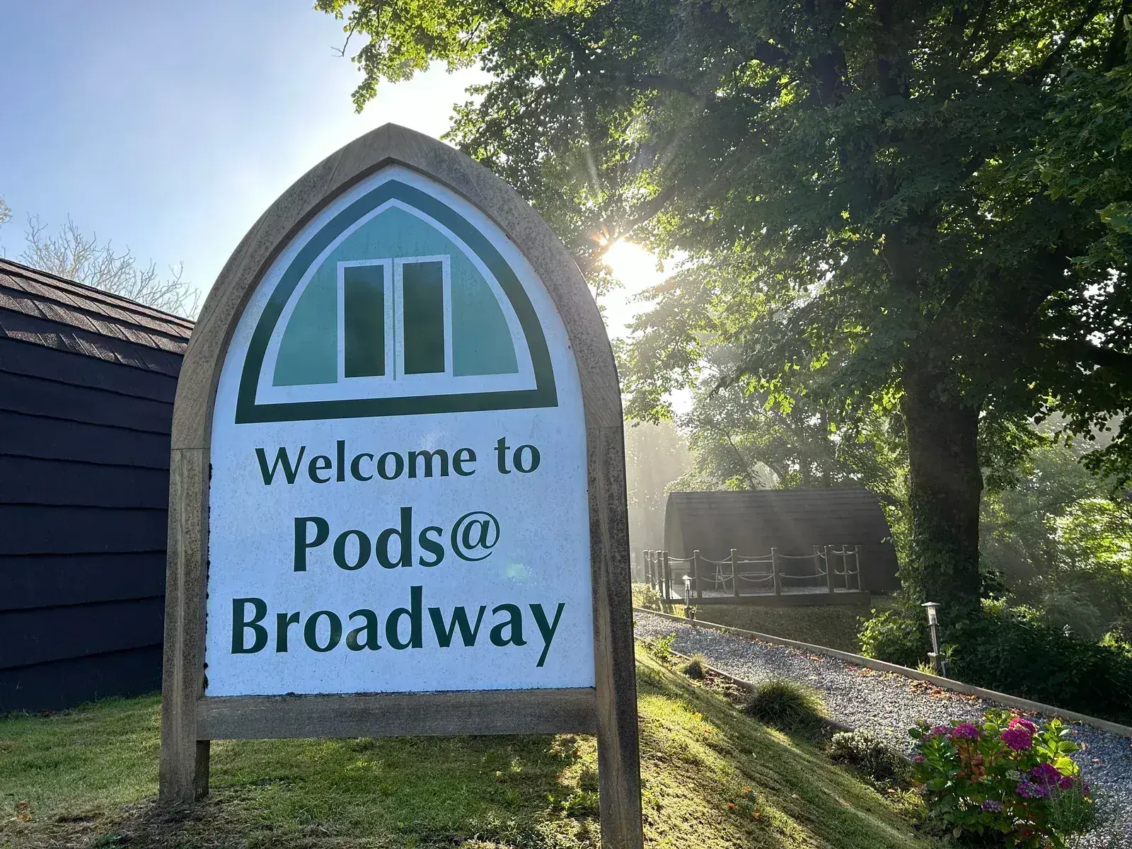 Welcome to Pods @ Broadway sign in morning sunlight, Laugharne