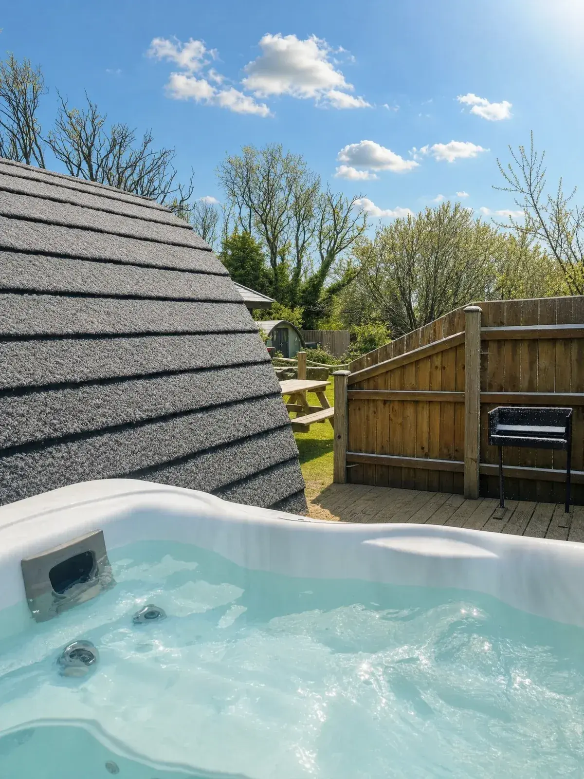 Private hot tub bubbling in the snow at Pods @ Broadway